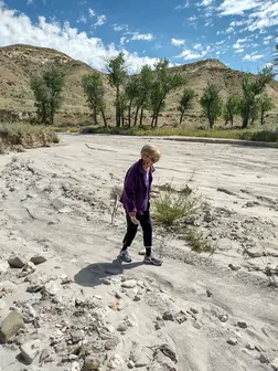 Woman Walking a Desert Riverbed